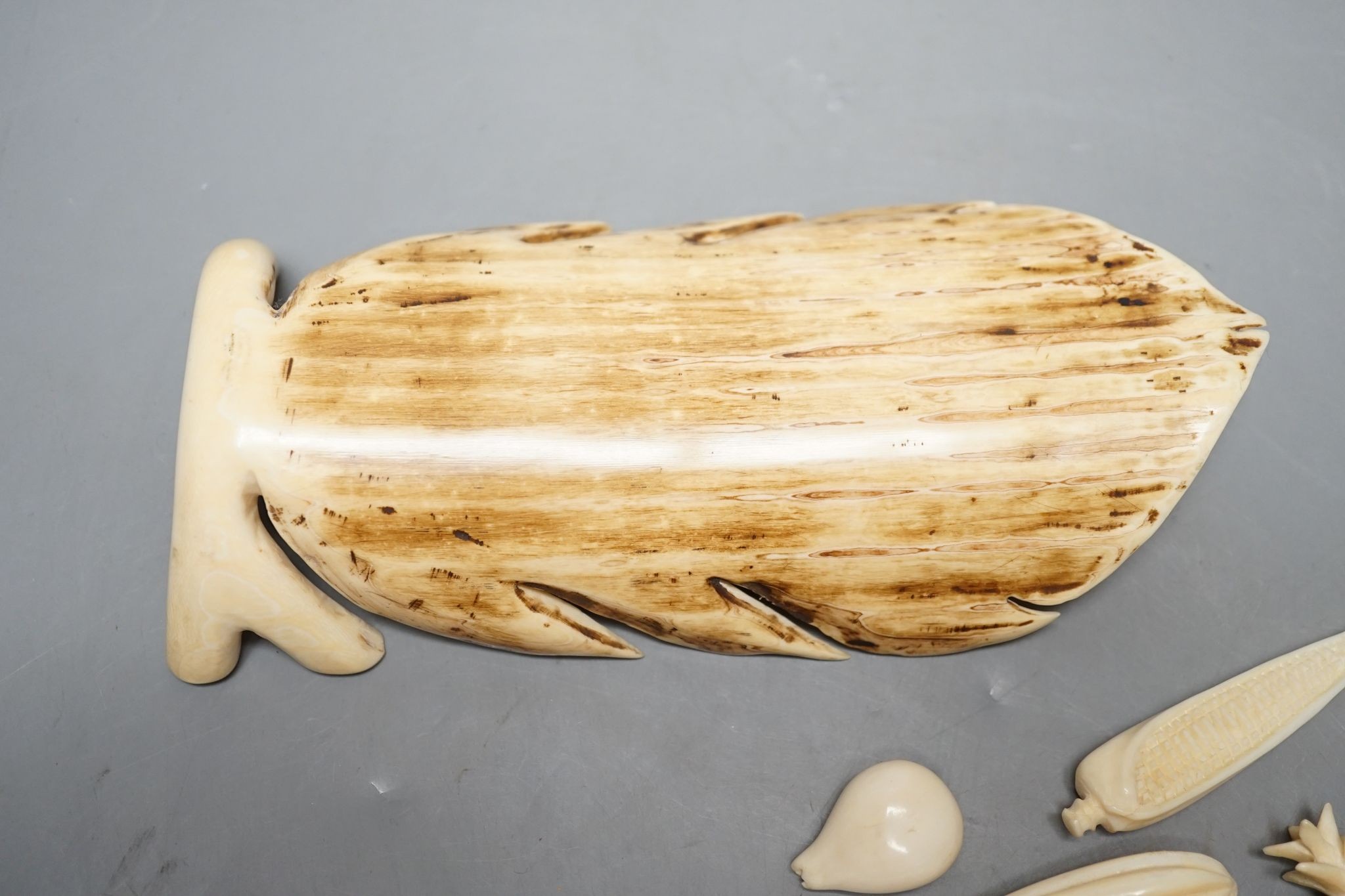 A group of Chinese carved ivory fruits, on ‘leaf’, 19cm
